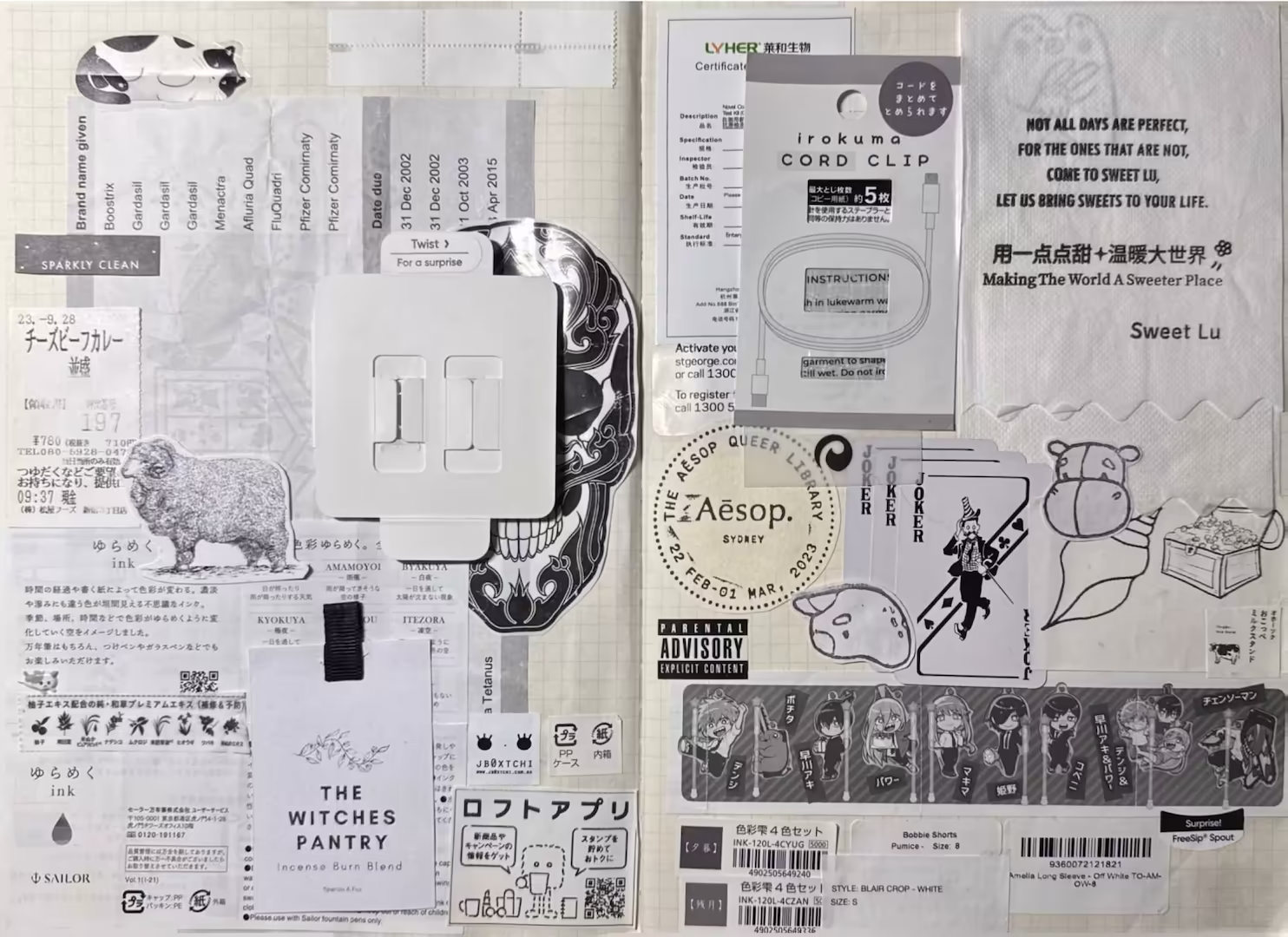 Black and white spread. The left side has Japanese information papers pasted on top of an immunisation history paper. There is a black and white lamb, a skull with an Apple cord on top and small packaging stickers. The right side has a printed napkin and caricatures surrounding it. There are small black and white Joker cards stacked, label stickers and Jujutsu Kaisen blind box paper.
